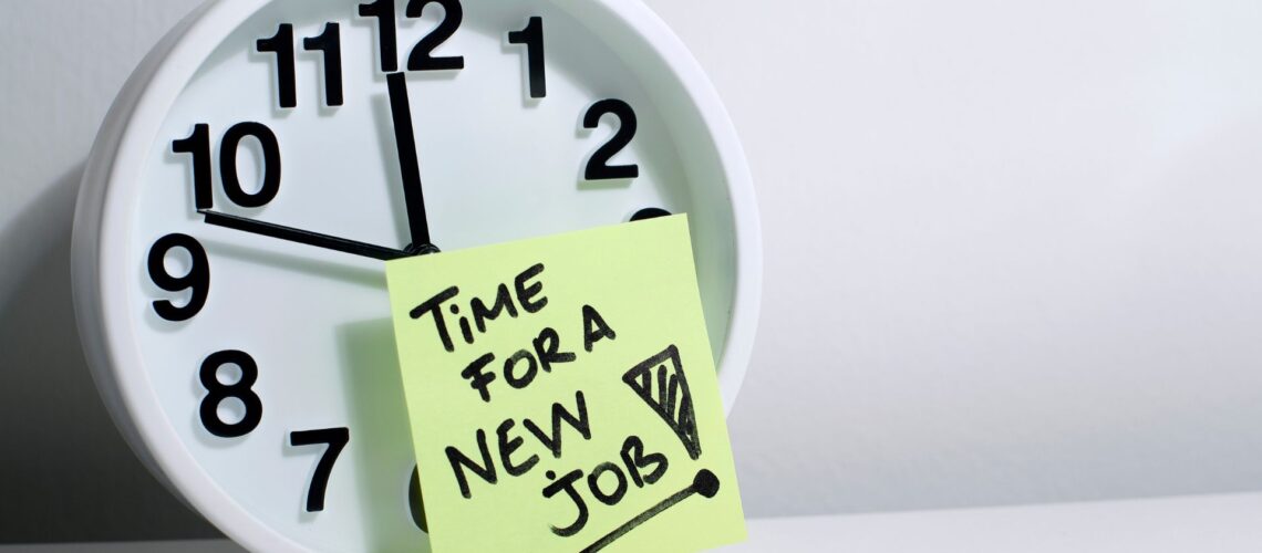 Clock with "Time for a New Job" post-it note attached