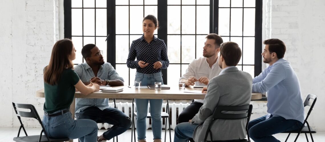 Leader guiding a team in discussion, representing leading from the front