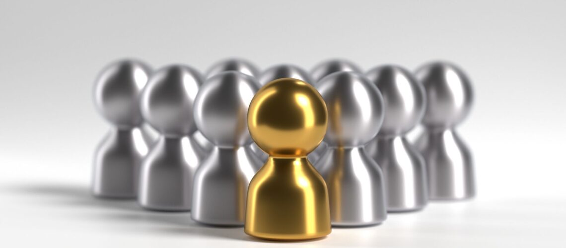 Gold leader figure standing in front of team representing visible leadership presence and active participation