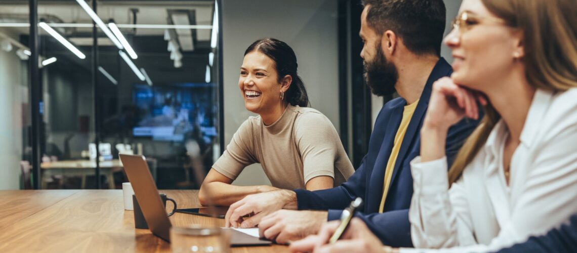 Diverse business team collaborating around conference table in modern office setting