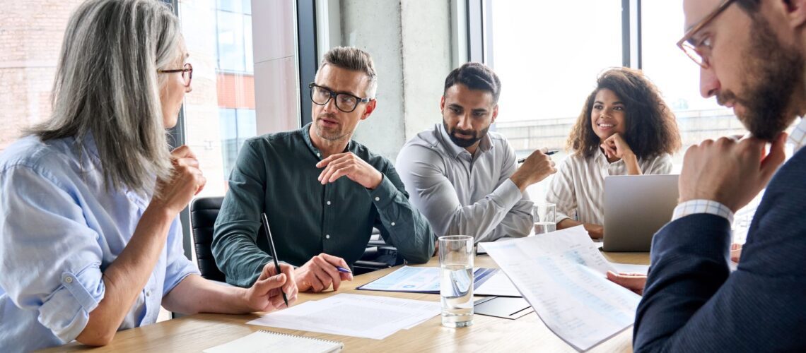 Diverse business team engaged in effective leadership communication during collaborative meeting