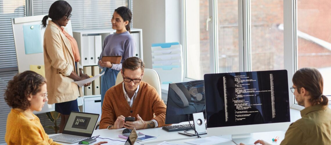 Professional technical team collaborating in modern workplace demonstrating values-based leadership principles