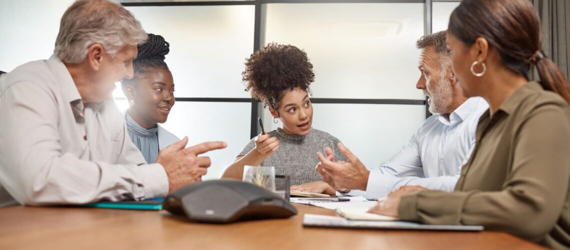 Professional team leader facilitating engaged discussion in modern conference room