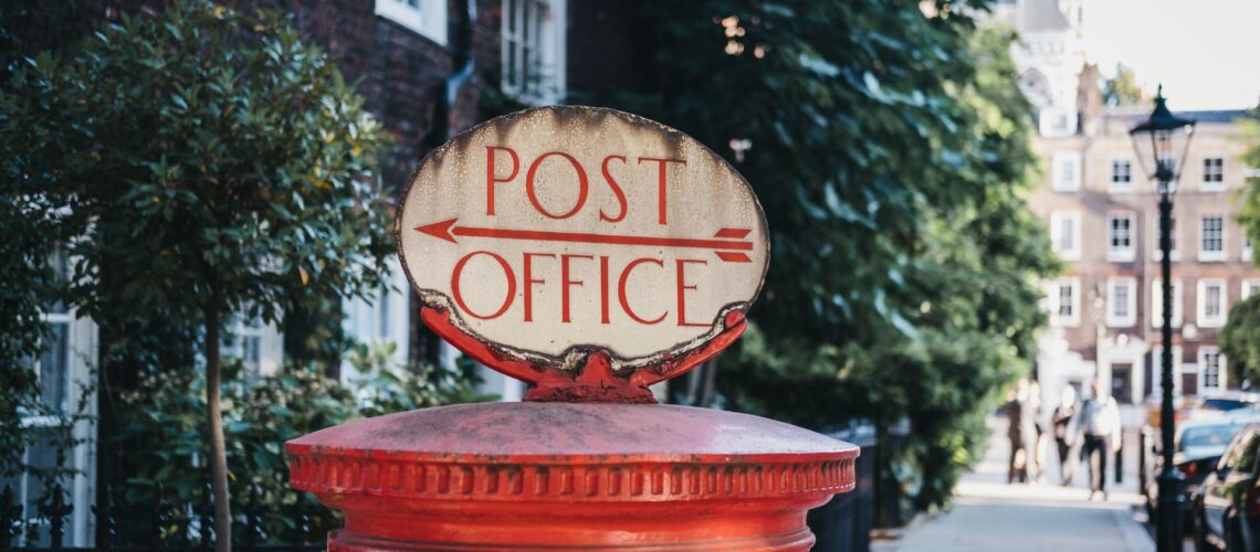 Traditional UK Post Office sign representing the institution at centre of accountability failure
