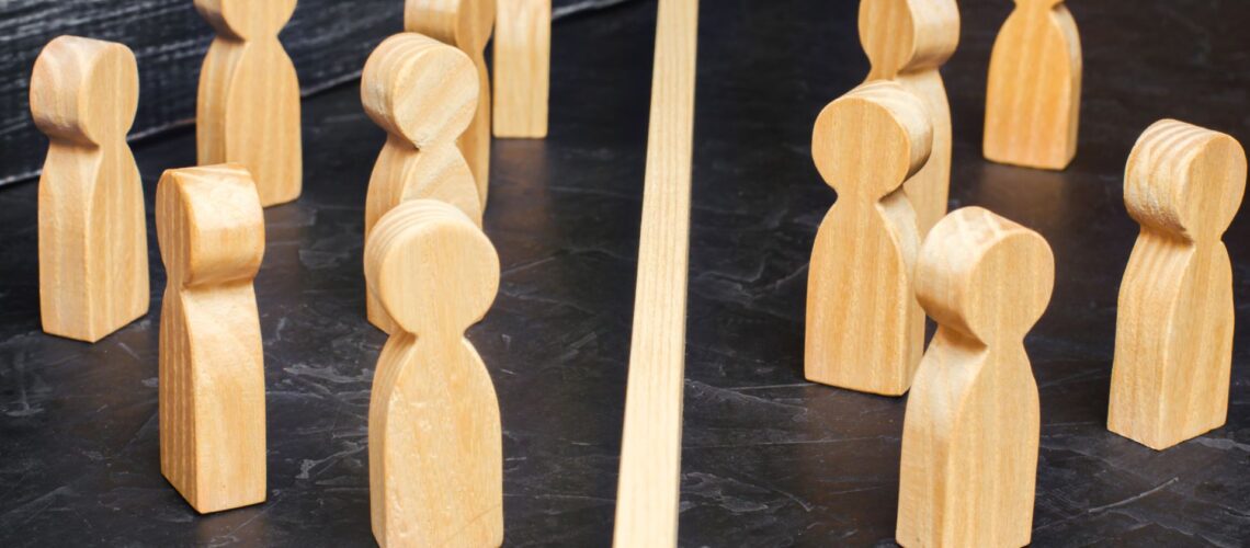 Wooden figurines representing different team members and leadership roles illustrating behavioural dynamics in workplace management