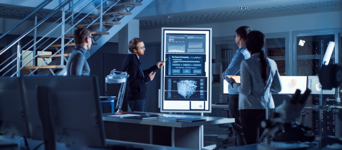 Business leader presenting AI data insights to diverse team in modern office environment