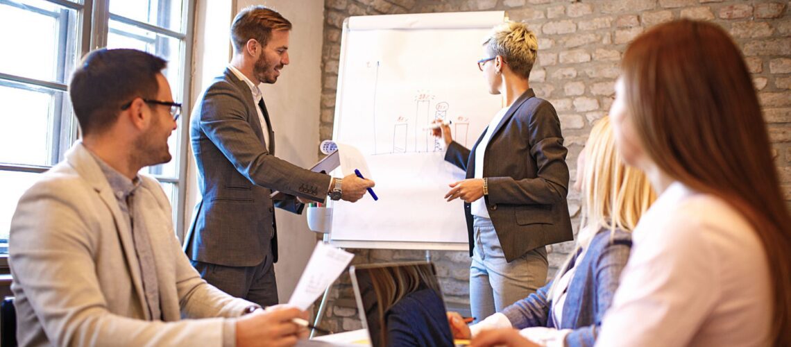 Business professionals collaborating in meeting discussing resilience strategies and team development