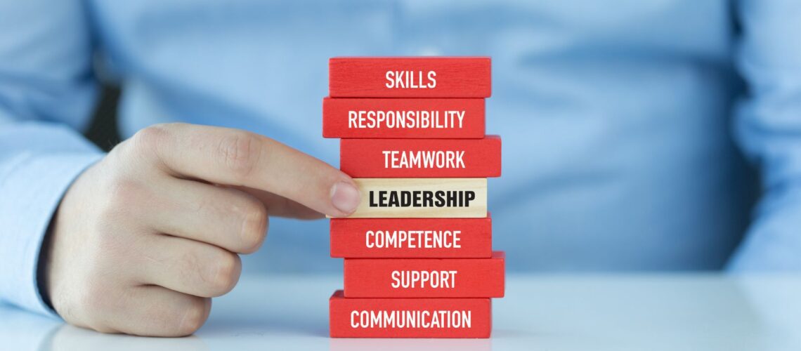 Professional building leadership competencies shown as stacked blocks including skills, responsibility, teamwork and communication
