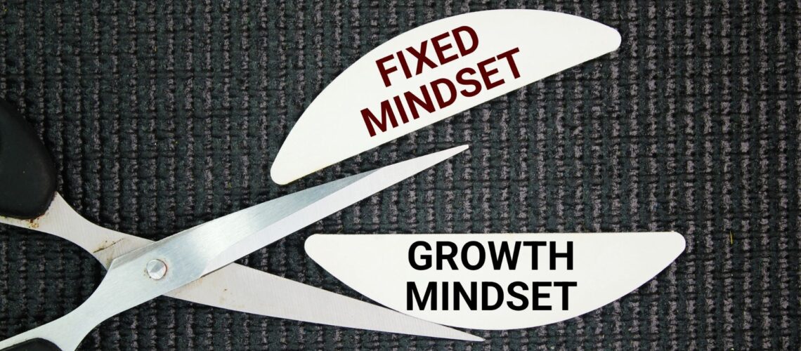 Scissors cutting fixed mindset label to reveal growth mindset, representing leadership adaptability and resilience transformation