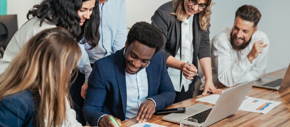 Diverse business team collaborating on strategic planning with data and documents, representing strategic leadership development in action