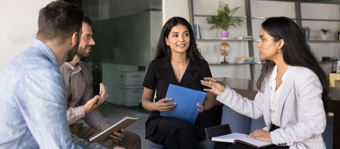 Professional facilitating collaborative team discussion demonstrating assertive leadership and mutual respect