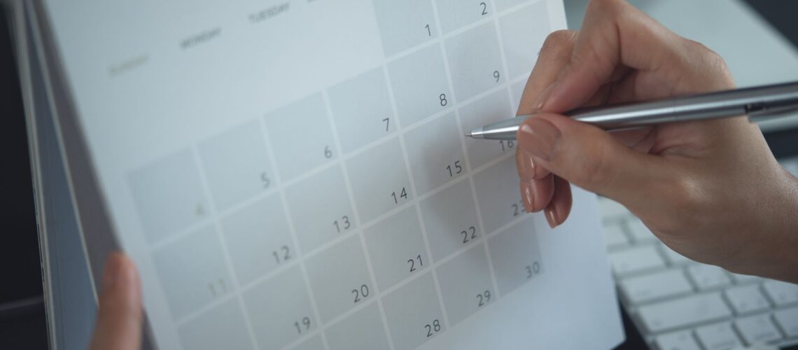 Professional scheduling protected strategic thinking time on digital calendar with pen for leadership planning