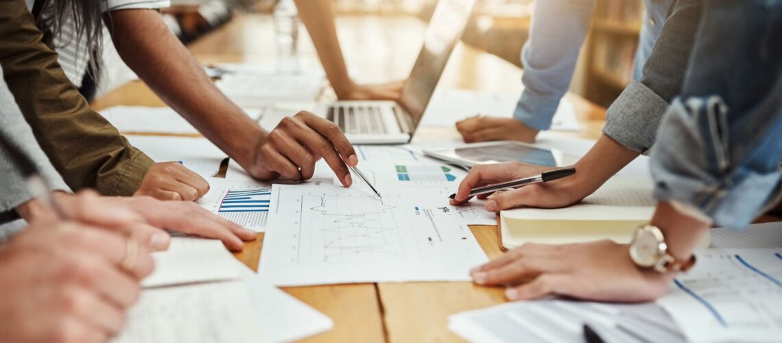 Professional team collaboratively analysing performance data demonstrating shared ownership and accountability culture